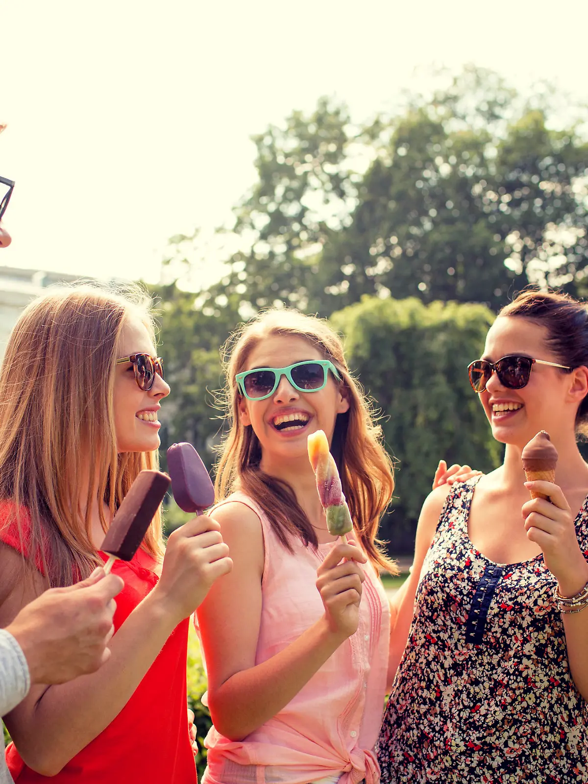 friendship, leisure, sweets, summer and people concept - group of smiling friends with ice cream outdoors