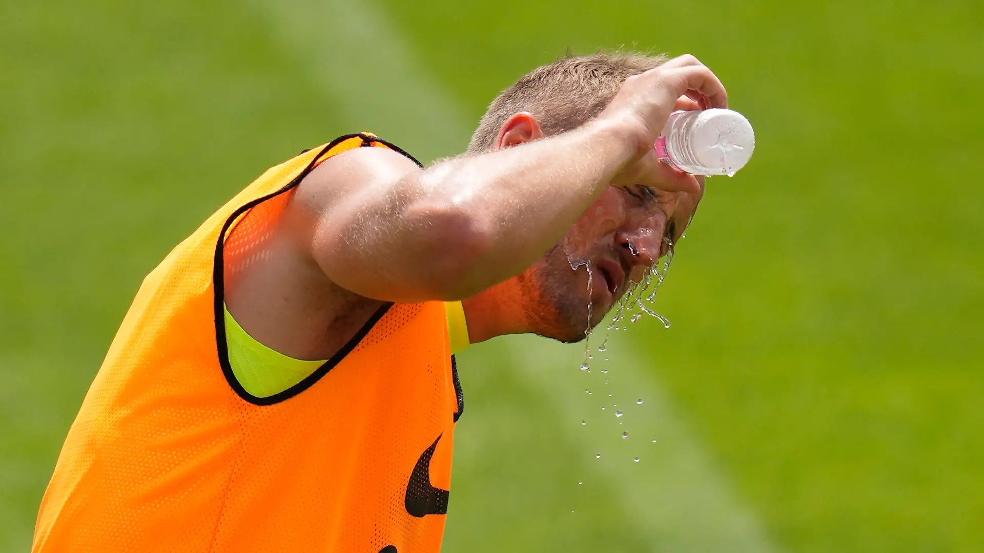 Tottenham's Harry Kane pours water on his face during a training session ahead of a friendly soccer match against Sevilla FC in Seoul, South Korea, Friday, July 15, 2022. Tottenham Hotspur will play a friendly match with Sevilla FC on July 16. (AP Photo/Lee Jin-man)
