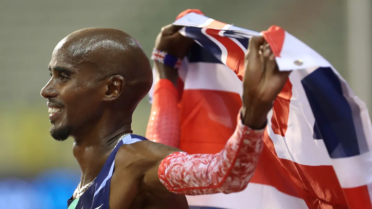 FILE - Britain's Mo Farah celebrates after winning the One Hour Men's race, at the Diamond League Memorial Van Damme athletics event where he set a new world record, at the King Baudouin stadium in Brussels on Friday, Sept. 4, 2020. It is hard to be first. Mo Farah this week went from being a gold medal-winning runner to the most prominent person ever to come forward as a victim of people trafficking. The four-time Olympic champion’s decision to tell the story of how he was exploited as a child gives a face to the often faceless victims of modern slavery, highlighting a crime that is often conflated with illegal immigration.  (AP Photo/Francisco Seco, File)