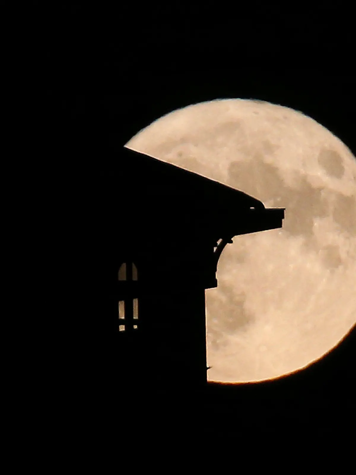 The supermoon rises behind a house in Saint Jean de Luz, southwestern France, Tuesday, Aug.1, 2023. The cosmos is offering up a double feature in August: a pair of supermoons culminating in a rare blue moon.  (AP Photo/Bob Edme)