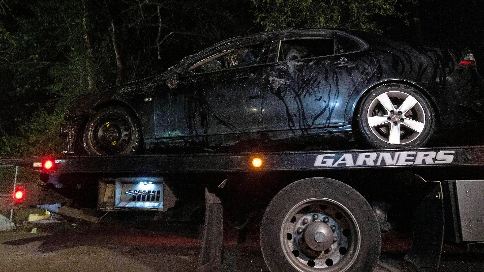 A car that matches the description of Kyle Moorman's vehicle was removed from the crime scene after the bodies of a man and three children were found Tuesday, July 12, 2022, on Bluff Road in Indianapolis. A dive team found a vehicle in the water, and the bodies of three children were inside, police said. (Grace Hollars/The Indianapolis Star via AP)