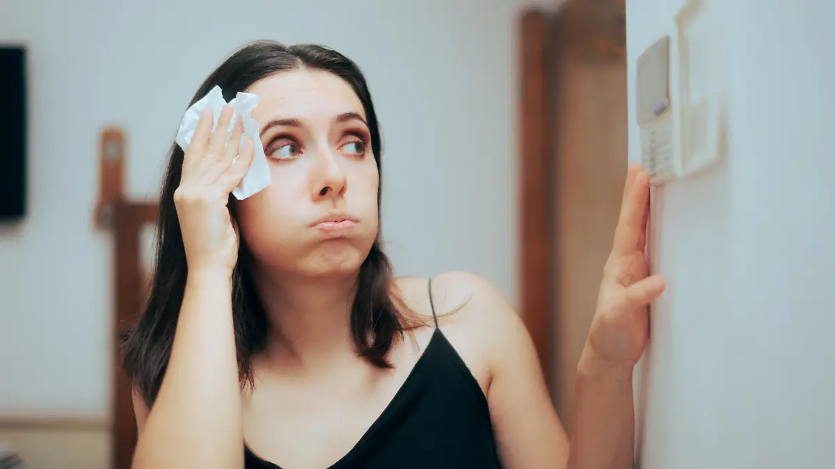 Person adjusting temperature from the AC settings