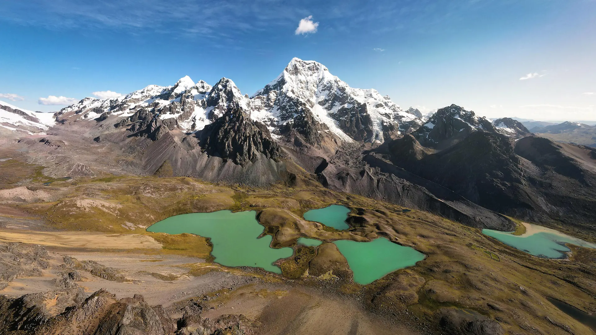 Creative Highlights World Breathtaking view of tranquil lakes with turquoise water located on slope of Ausangate mountain near snowy peaks against cloudy blue sky in Peru TheTrioStudio_AusangateMountainPeru_00002.jpg Copyright: xThexTrioxStudiox