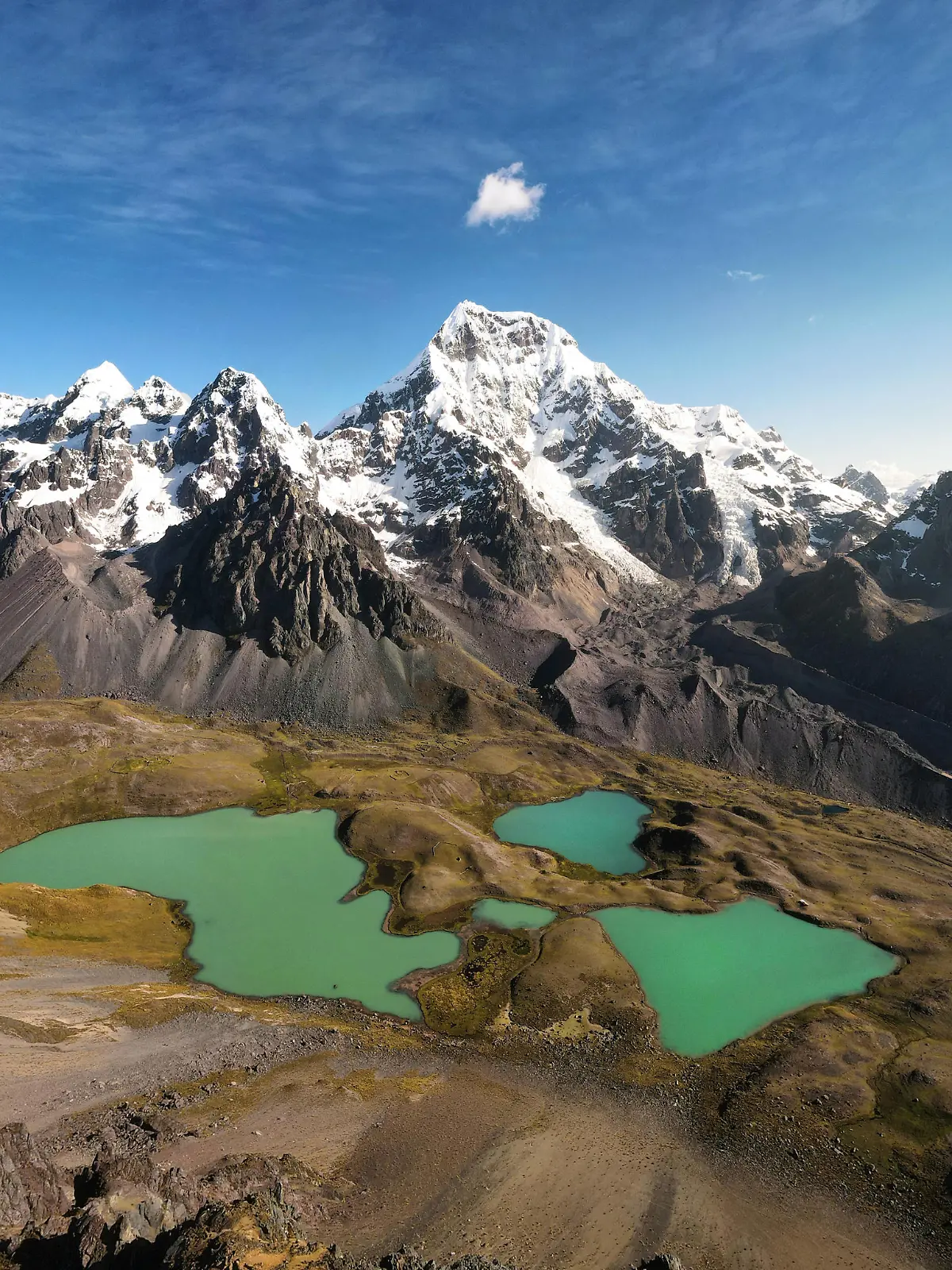 Creative Highlights World Breathtaking view of tranquil lakes with turquoise water located on slope of Ausangate mountain near snowy peaks against cloudy blue sky in Peru TheTrioStudio_AusangateMountainPeru_00002.jpg Copyright: xThexTrioxStudiox