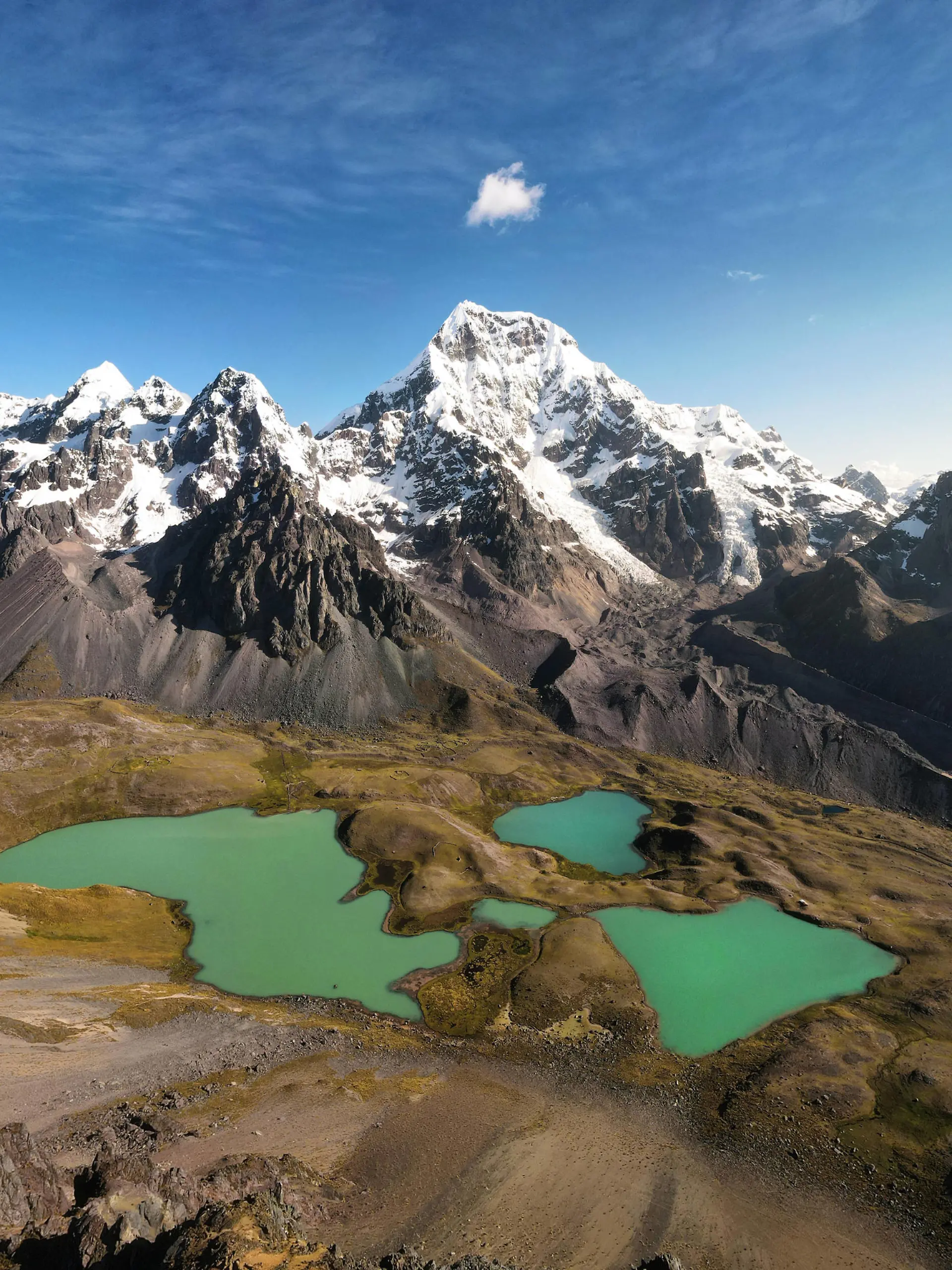 Creative Highlights World Breathtaking view of tranquil lakes with turquoise water located on slope of Ausangate mountain near snowy peaks against cloudy blue sky in Peru TheTrioStudio_AusangateMountainPeru_00002.jpg Copyright: xThexTrioxStudiox