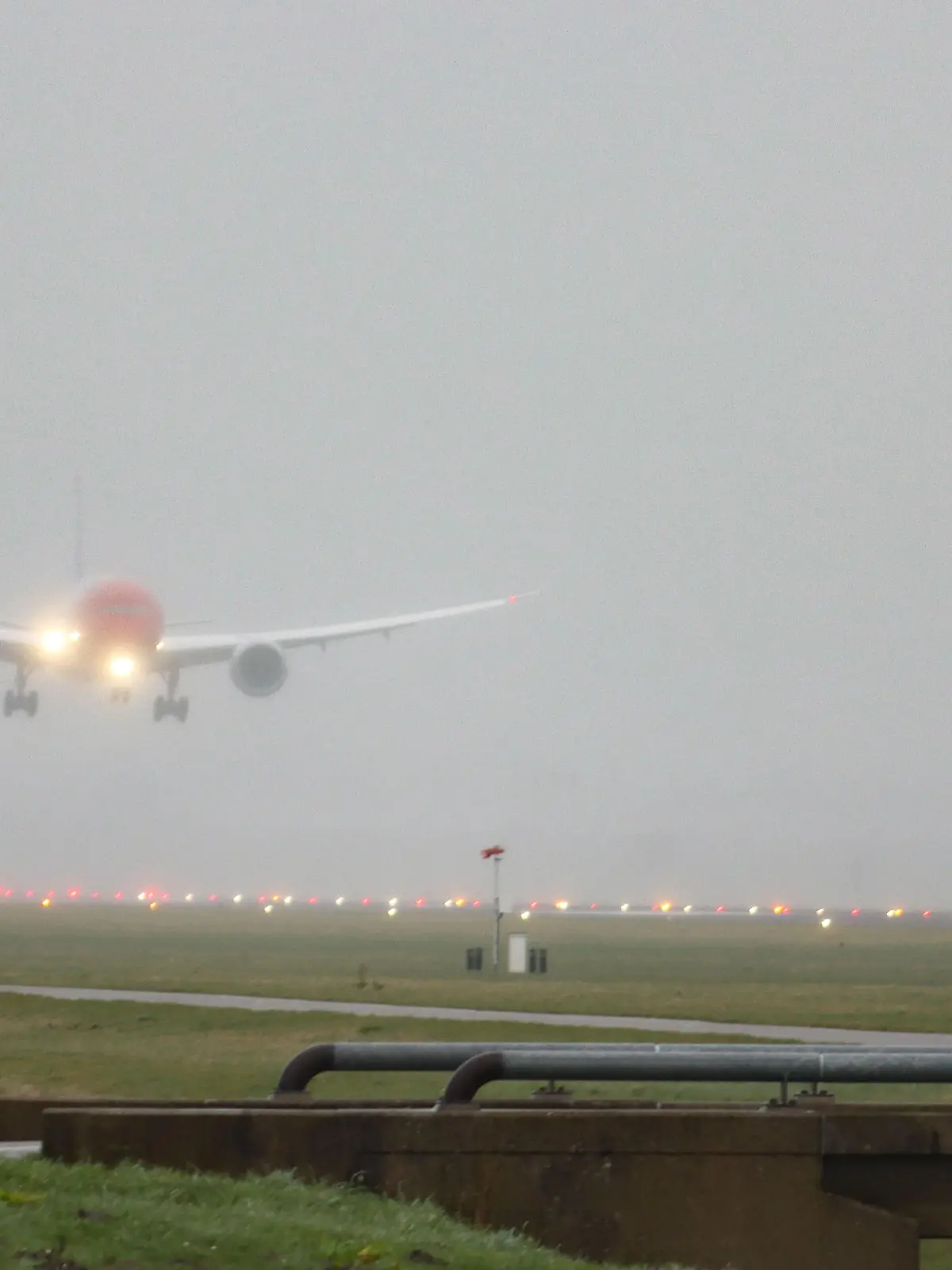 Norwegian Air Sweden Boeing 787-9 Dreamliner aircraft as seen on final approach landing on Polderbaan runway and taxiing at Amsterdam Schiphol International Airport AMS EHAM in The Netherlands during a rainy day in haze. The wide body commercial airplane has the registration SE-RXM, 2x RR Rolls Royce jet engines and the name Asger Jorn. Norwegian Air Sweden AB is a Swedish low-cost airline and a fully integrated subsidiary of Norwegian Air Shuttle, using its corporate identity. February 28, 2020 (Photo by Nicolas Economou/NurPhoto)