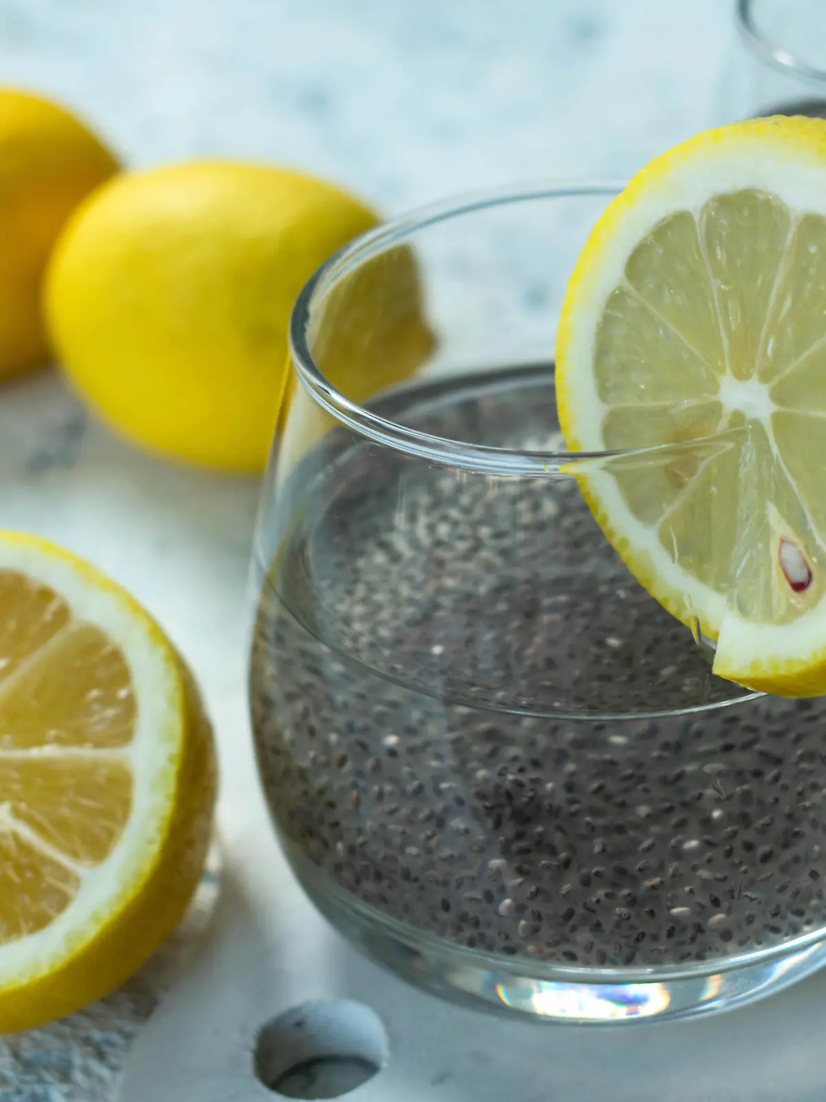 Water with chia seeds and lemon on  a white background. A useful drink for weight loss.