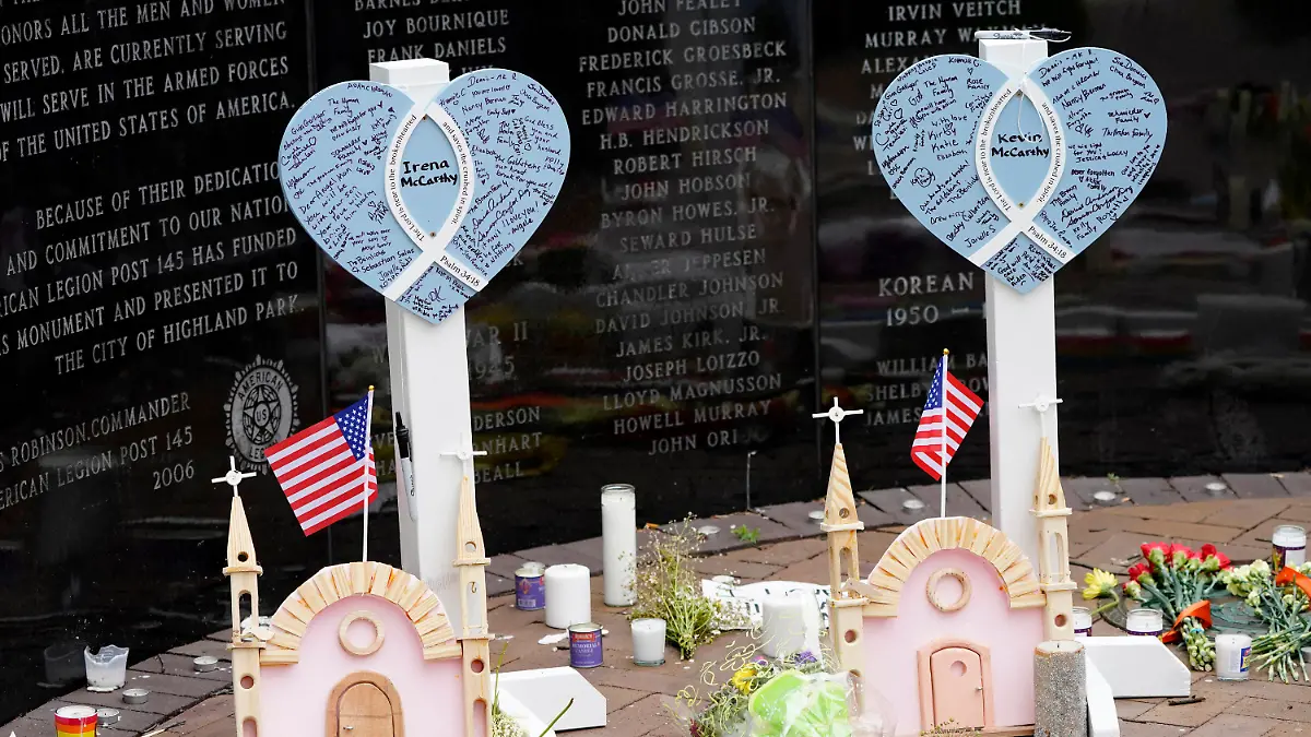 Memorials for Irina and Kevin McCarthy, two of seven people killed in Monday's Fourth of July parade mass shooting, stands within a veterans memorial Wednesday, July 6, 2022, in Highland Park, Ill. (AP Photo/Charles Rex Arbogast)