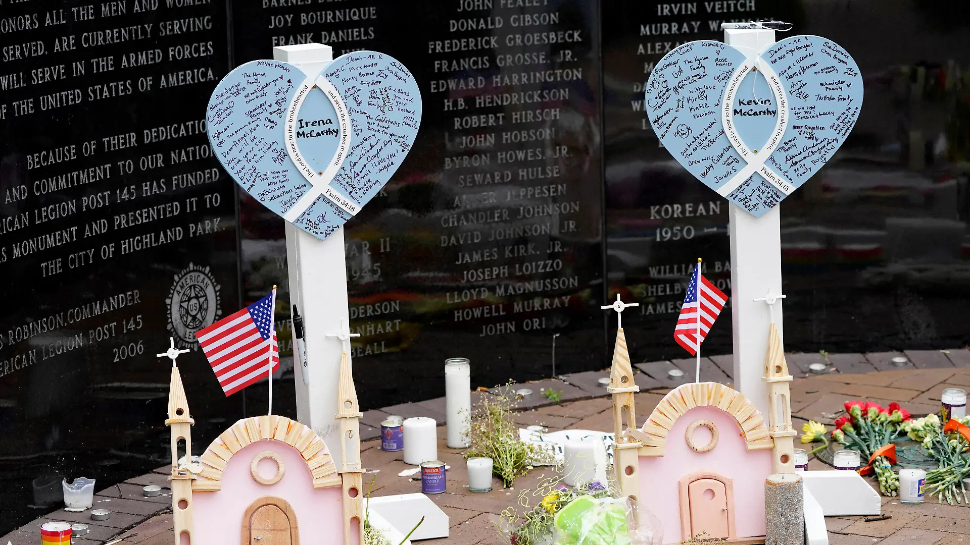 Memorials for Irina and Kevin McCarthy, two of seven people killed in Monday's Fourth of July parade mass shooting, stands within a veterans memorial Wednesday, July 6, 2022, in Highland Park, Ill. (AP Photo/Charles Rex Arbogast)