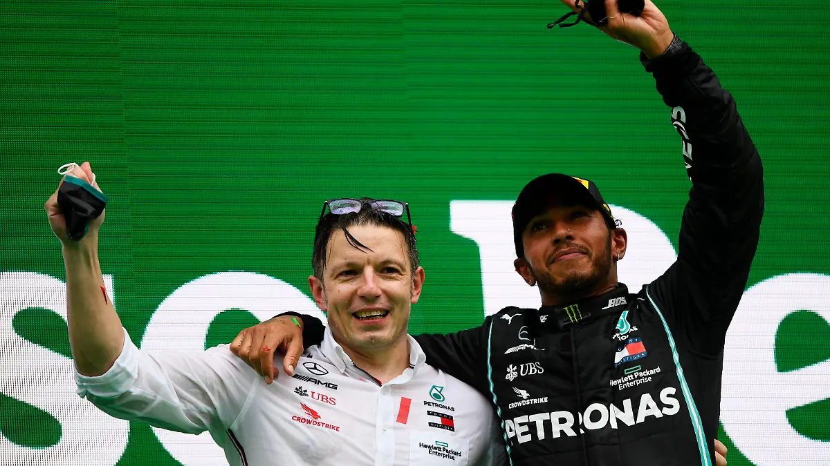 PORTIMAO, PORTUGAL - OCTOBER 25: Race winner Lewis Hamilton of Great Britain and Mercedes GP celebrates his record breaking 92nd race win with race engineer Peter Bonnington on the podium during the F1 Grand Prix of Portugal at Autodromo Internacional do Algarve on October 25, 2020 in Portimao, Portugal. (Photo by Rudy Carezzevoli/Getty Images)