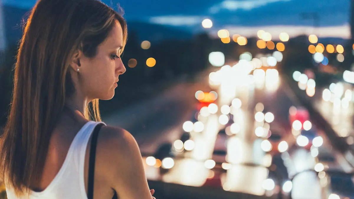 Thoughtful woman outside at night