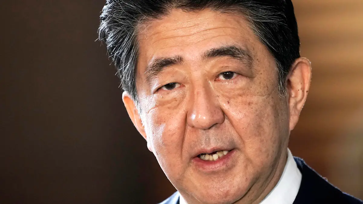 CORRECTS DATE - FILE - Japan's outgoing Prime Minister Shinzo Abe speaks to the media as he arrives at the prime minister's office for a cabinet meeting in Tokyo on Sept. 16, 2020. Japan’s NHK TV says on Friday, July 8, 2022, former Prime Minister Abe apparently was shot at and collapsed during a campaign speech. (AP Photo/Eugene Hoshiko, File)