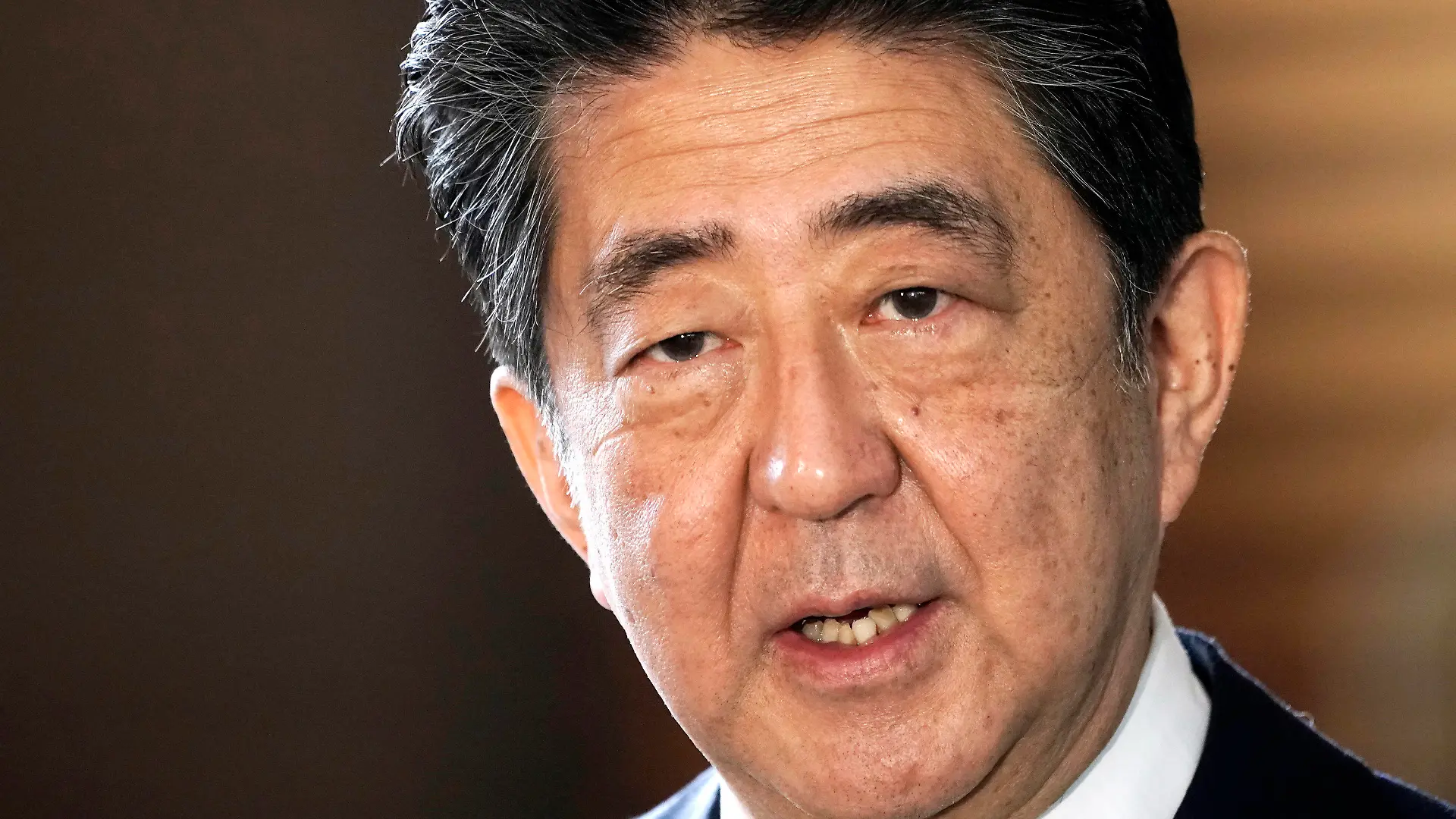 CORRECTS DATE - FILE - Japan's outgoing Prime Minister Shinzo Abe speaks to the media as he arrives at the prime minister's office for a cabinet meeting in Tokyo on Sept. 16, 2020. Japan’s NHK TV says on Friday, July 8, 2022, former Prime Minister Abe apparently was shot at and collapsed during a campaign speech. (AP Photo/Eugene Hoshiko, File)