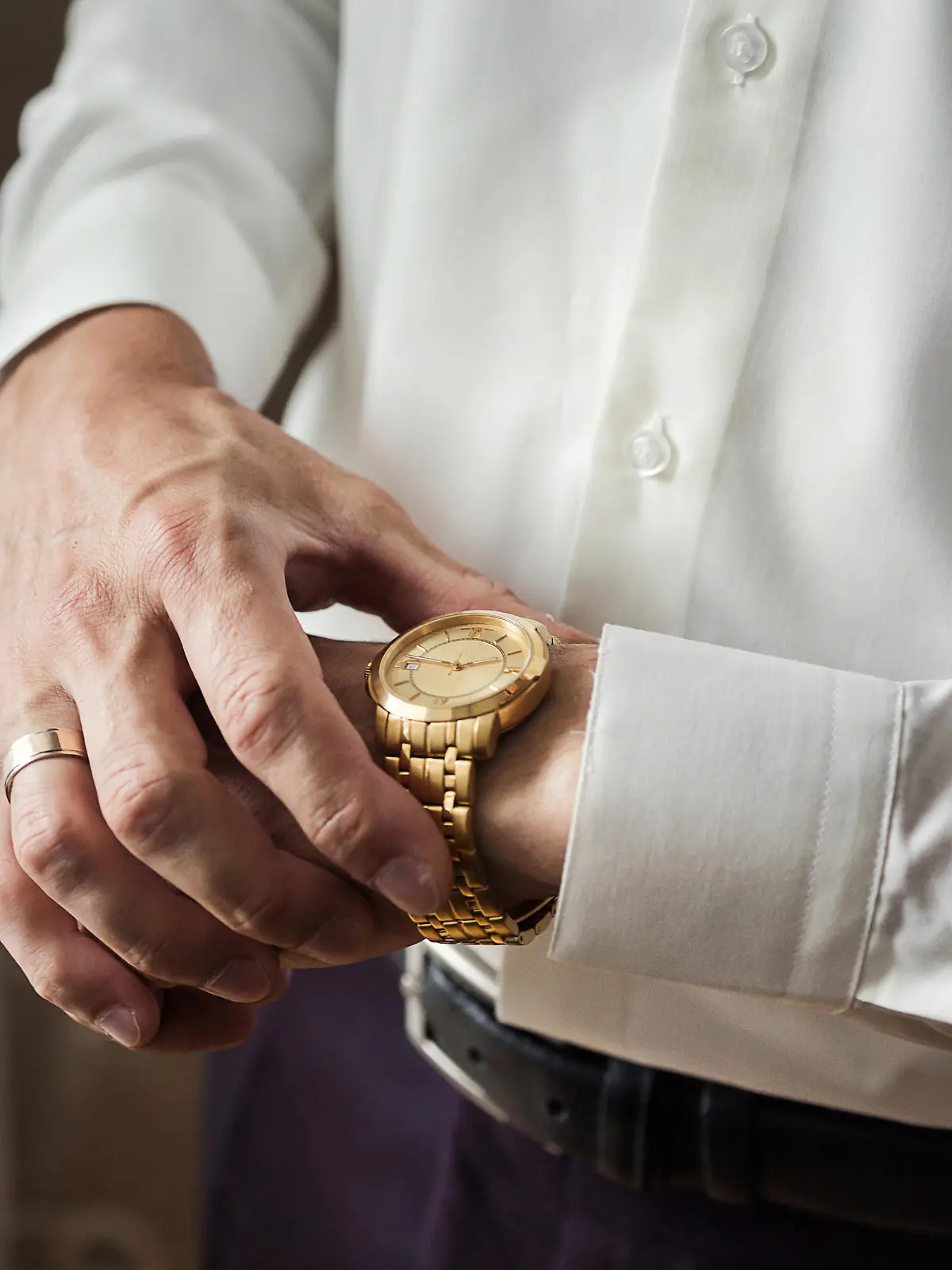 businessman checking time on his wrist watch, man putting clock on hand,groom getting ready in the morning before wedding ceremony