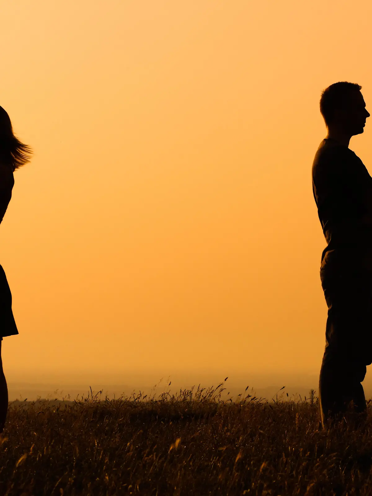 Silhouette of a angry woman and man on each other.