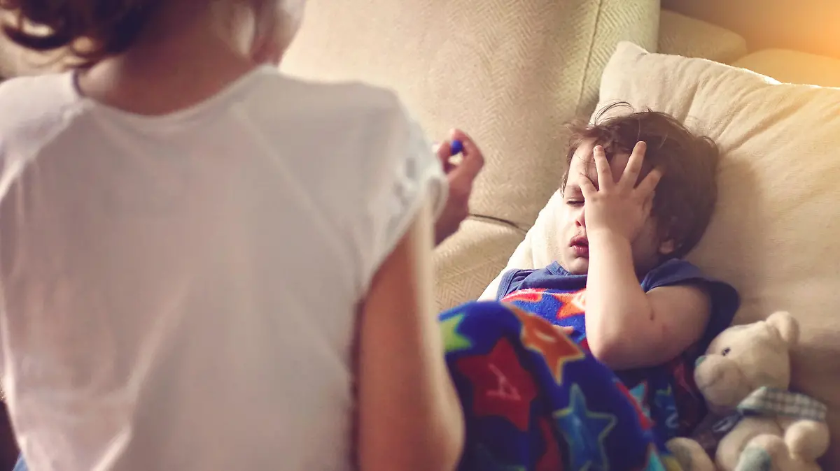 mother checking her sons temperature