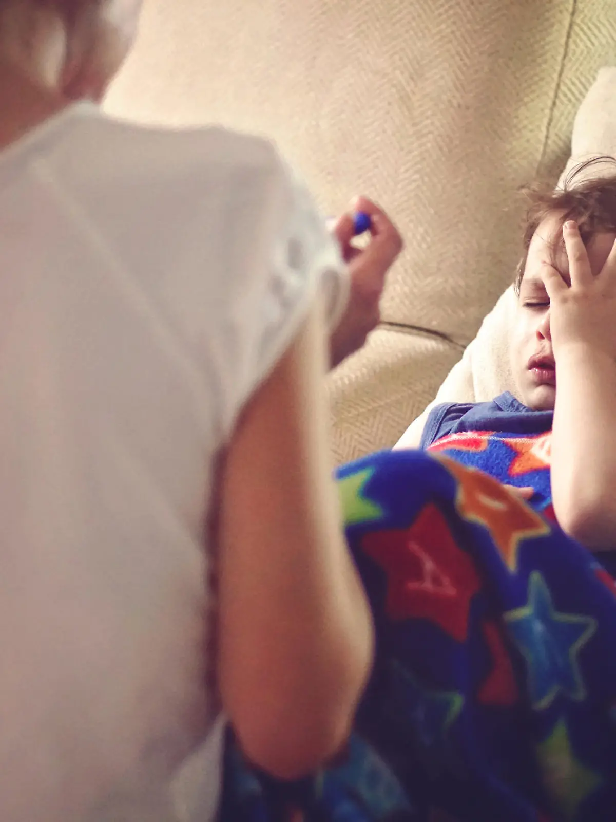 mother checking her sons temperature