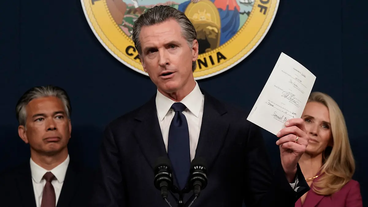FILE - California Gov. Gavin Newsom displays a bill he just signed that shields abortion providers and volunteers in California from civil judgements from out-of-state courts during a news conference in Sacramento, Calif., Friday, June 24, 2022. Newsom angrily denounced the Supreme Court decision to overturn Roe v. Wade. (AP Photo/Rich Pedroncelli, File)