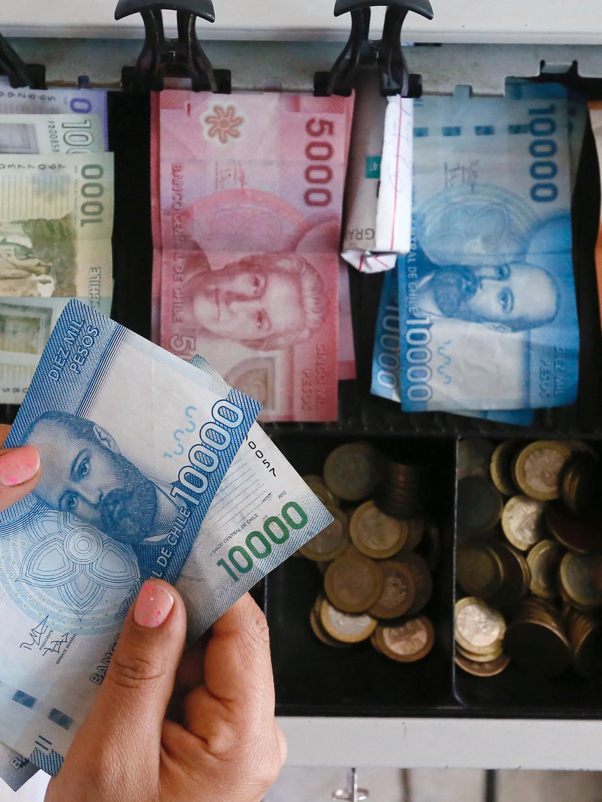 FILE PHOTO: Chilean pesos and coins are seen in this picture illustration, August 16, 2016. REUTERS/Rodrigo Garrido/Illustration/File Photo