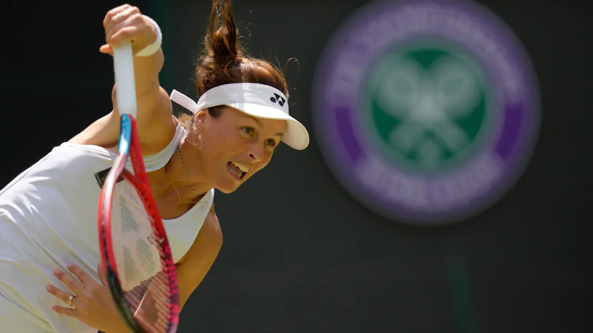 Germany's Tatjana Maria serves to Germany's Jule Niemeier in a women's singles quarterfinal match at the Wimbledon tennis championships in London, Tuesday July 5, 2022. (AP Photo/Kirsty Wigglesworth)