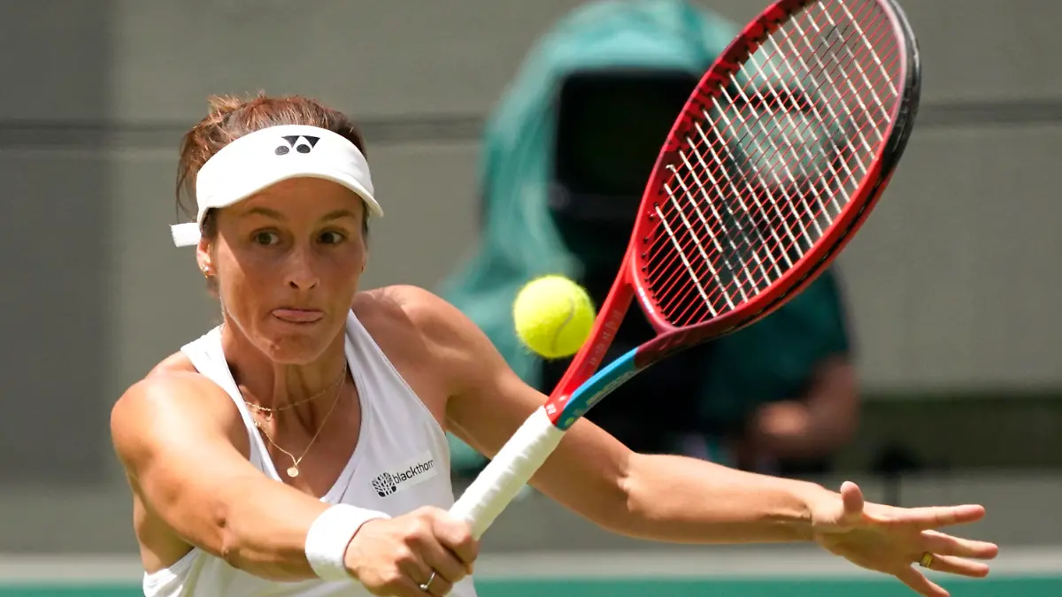 Germany's Tatjana Maria returns the ball to Latvia's Jelena Ostapenko during a fourth round women's singles match on day seven of the Wimbledon tennis championships in London, Sunday, July 3, 2022. (AP Photo/Alberto Pezzali)