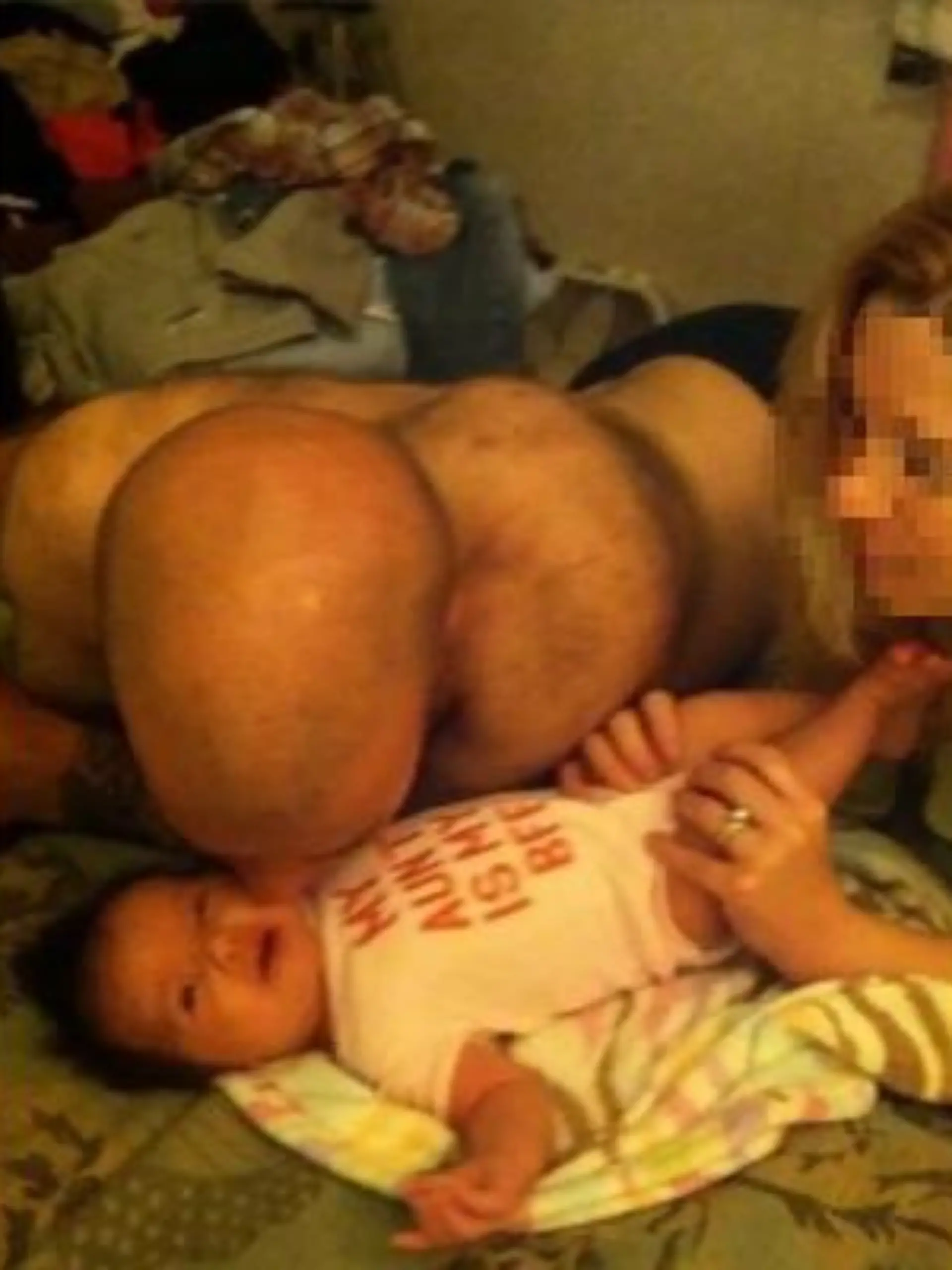 Optische Täuschung: Vater küsst Baby, es sieht jedoch so aus, als halte er seinen Hintern ins Bild.