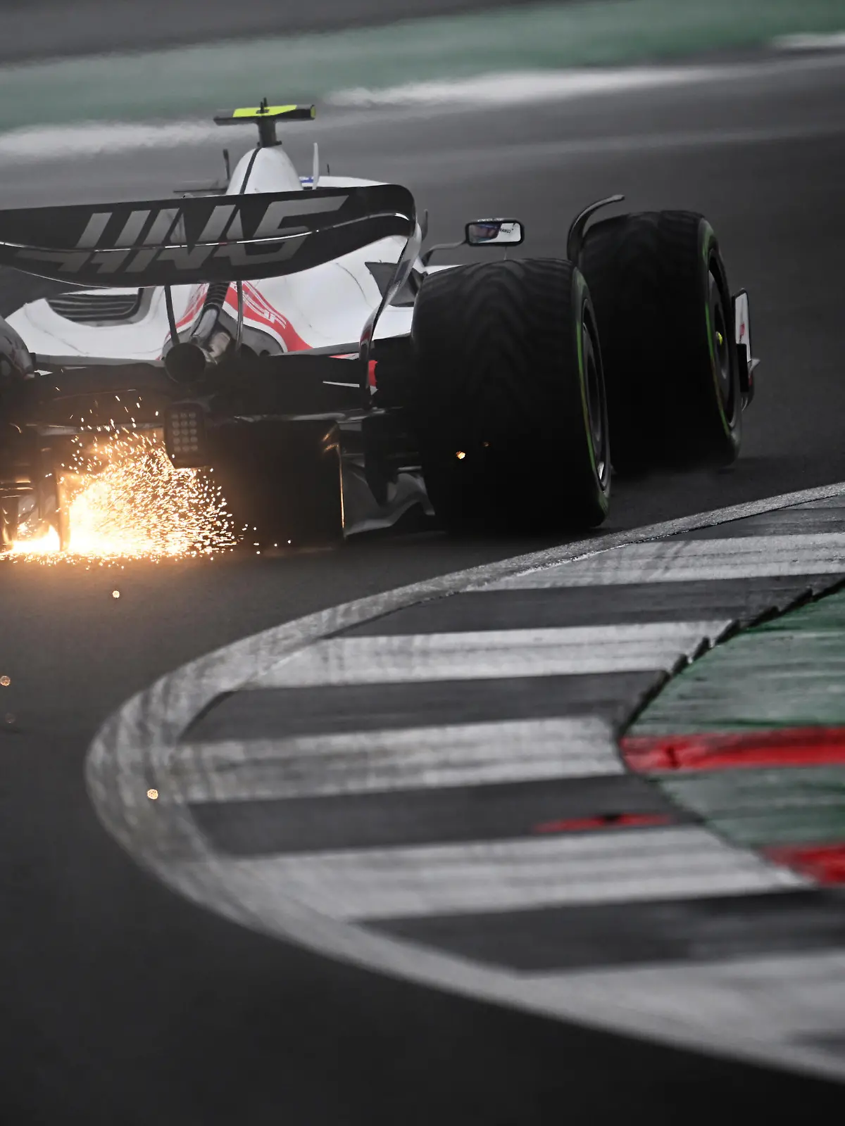NORTHAMPTON, ENGLAND - JULY 02: Sparks fly behind Mick Schumacher of Germany driving the (47) Haas F1 VF-22 Ferrari during qualifying ahead of the F1 Grand Prix of Great Britain at Silverstone on July 02, 2022 in Northampton, England. (Photo by Clive Mason/Getty Images)