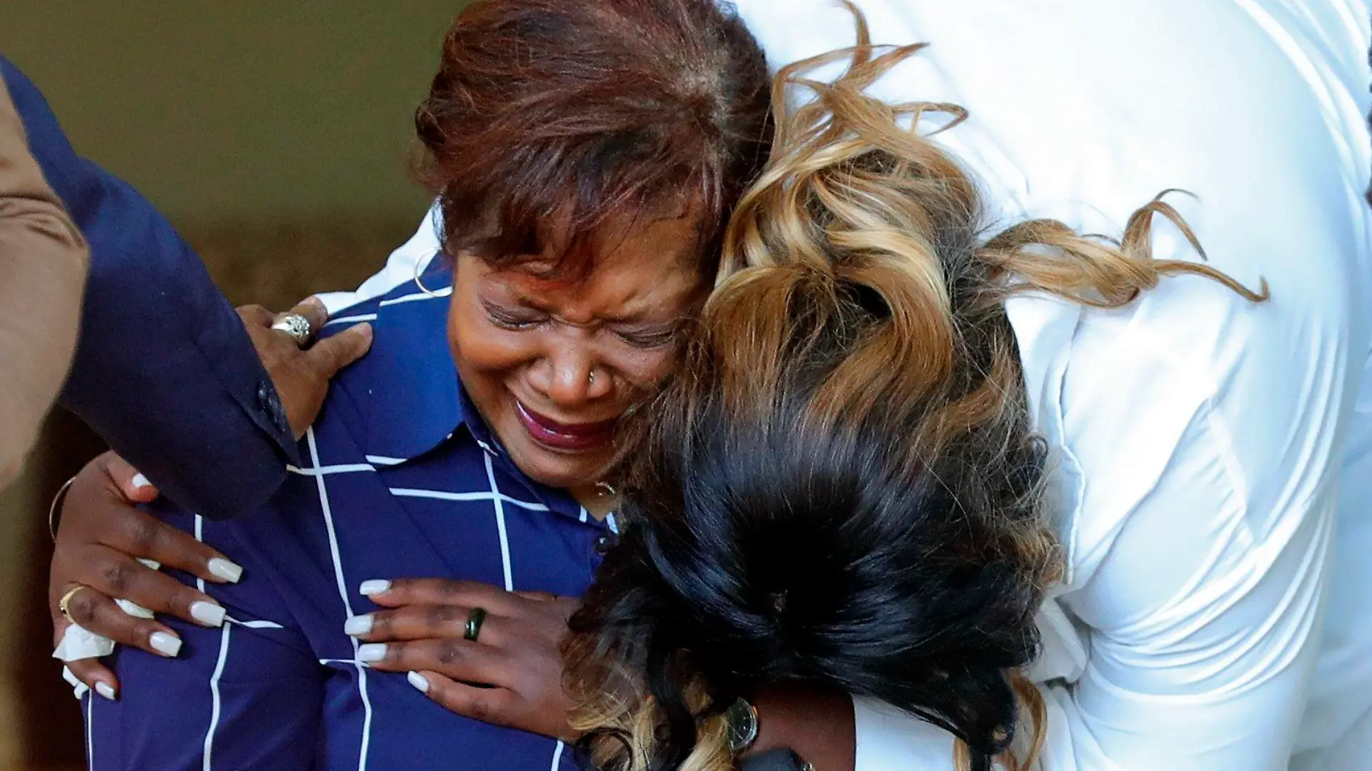 Pamela Walker, left, and Jada Walker, right, get emotional during a news conference following the shooting death of Jayland Walker, Thursday, June 30, 2022, in Akron, Ohio. Walkler, shot and killed by police following a vehicle and foot pursuit this week died from multiple gunshot wounds, and his death has been ruled a homicide, authorities announced Wednesday.(Jeff Lange /Akron Beacon Journal via AP)