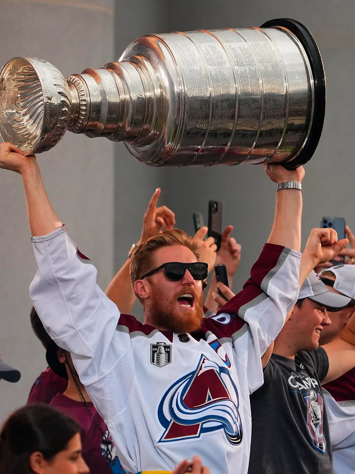Colorado Avalanche left wing Gabriel Landeskog hoists the Stanley Cup at a rally for the NHL hockey champions Thursday, June 30, 2022, in Denver. (AP Photo/Jack Dempsey)