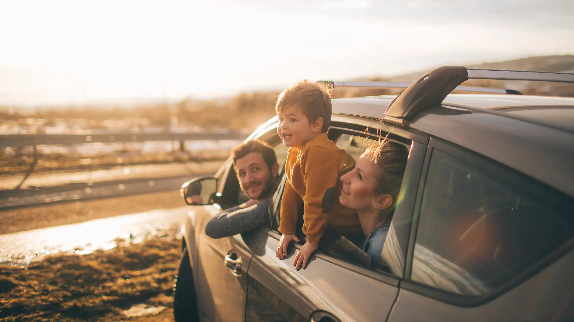 Photo of cute little family during their excursion with family car