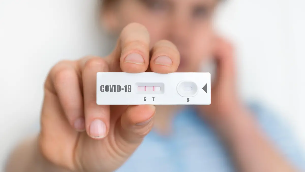 Rapid test on COVID-19 in hands of woman with positive result
