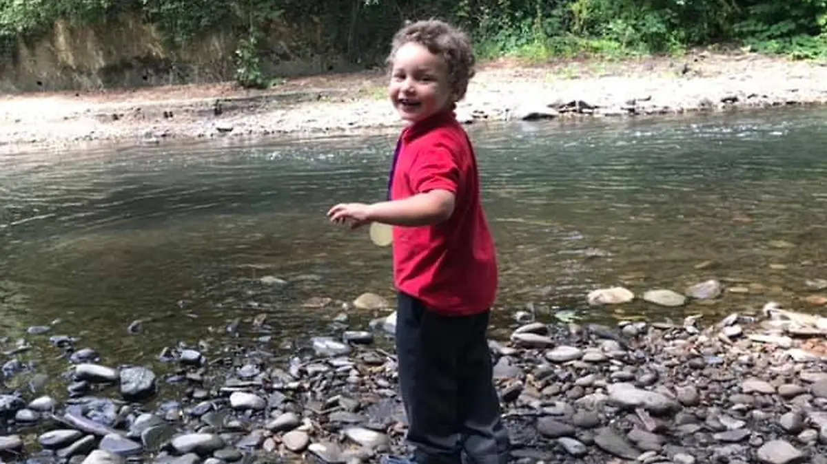 Pictured: The five year old who died in Ogmore river, named locally as Logan Williamson, pictured by Ogmore river on July 2019.
Re: South Wales Police can confirm that  three people have been arrested following reports of concerns for a missing 5 year old boy in Sarn, Bridgend, and the subsequent finding of the body in the Ogmore River near Pandy Park, Bridgend, Wales, UK.
A 39 year male, 30 year female and 13 year old male, all from the Bridgend area, have been arrested on suspicion of murder and are currently in police custody.  We are not looking for anyone else in relation to this incident.