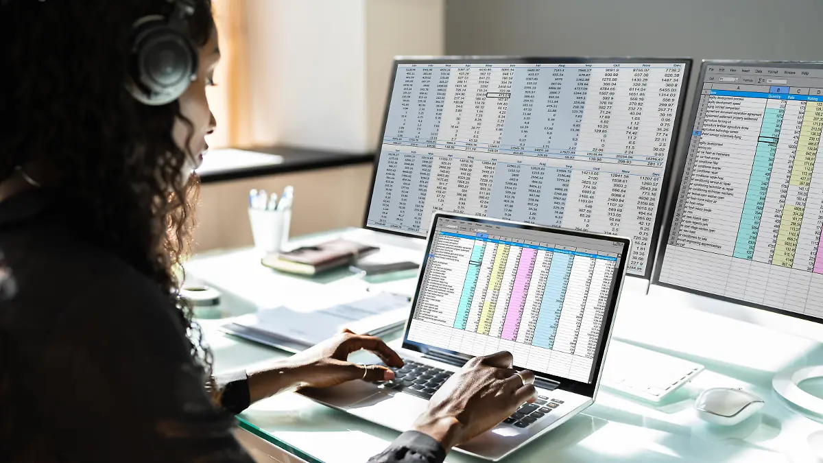 Data Analyst African Woman Using Spreadsheet On Computer