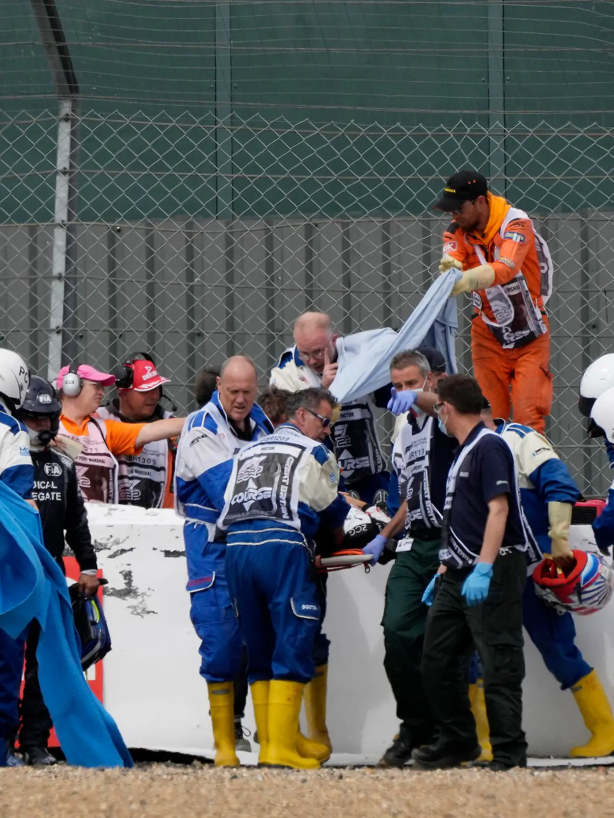 Formula One F1 - British Grand Prix - Silverstone Circuit, Silverstone, Britain - July 3, 2022 Alfa Romeo's Guanyu Zhou receives medical attention after he crashes out at the start of the race Pool via REUTERS/Matt Dunham