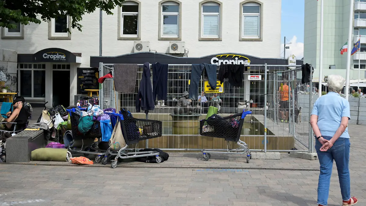 A public fountain is surrounded by a fence, where dozens of punks took over a place, who travelled with a special nine euro ticket from Deutsche Bahn, a German national railway company, that allows the usage of local buses and trains nationwide for a month, in downtown Westerland on the German island of Sylt, Germany, June 25, 2022. REUTERS/Fabian Bimmer