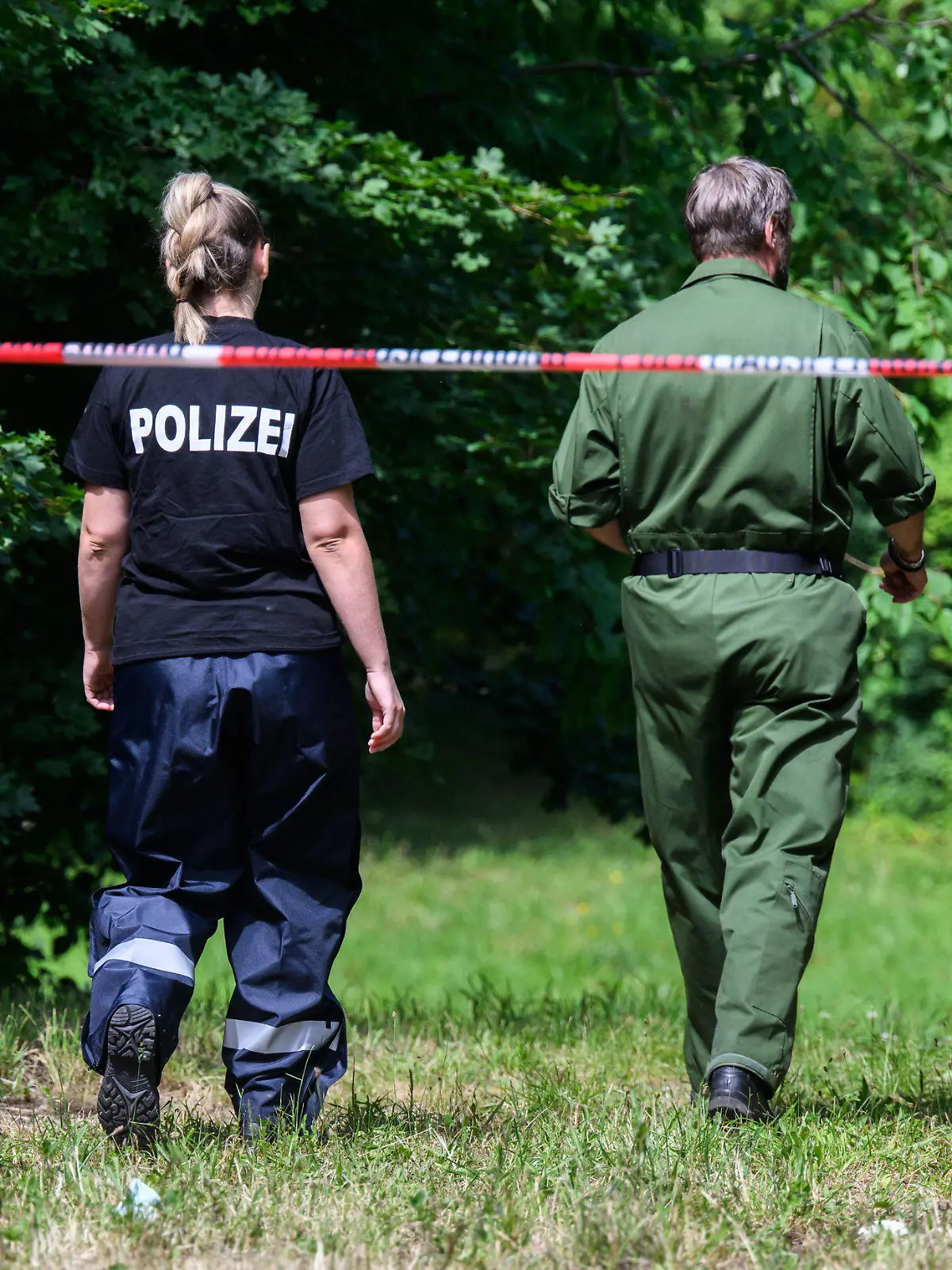 22.06.2022, Niedersachsen, Salzgitter: Mitarbeiter der Spurensicherung der Polizei Salzgitter stehen an einem Tatort an einer Grünfläche am Hans-Böckler-Ring. Nach dem Fund einer toten 15-Jährigen in Salzgitter gelten zwei Jugendliche als dringend tatverdächtig. Es handele sich um einen 13-Jährigen und einen 14-Jährigen, teilte die Staatsanwaltschaft Braunschweig am Mittwoch mit. Foto: Julian Stratenschulte/dpa +++ dpa-Bildfunk +++
