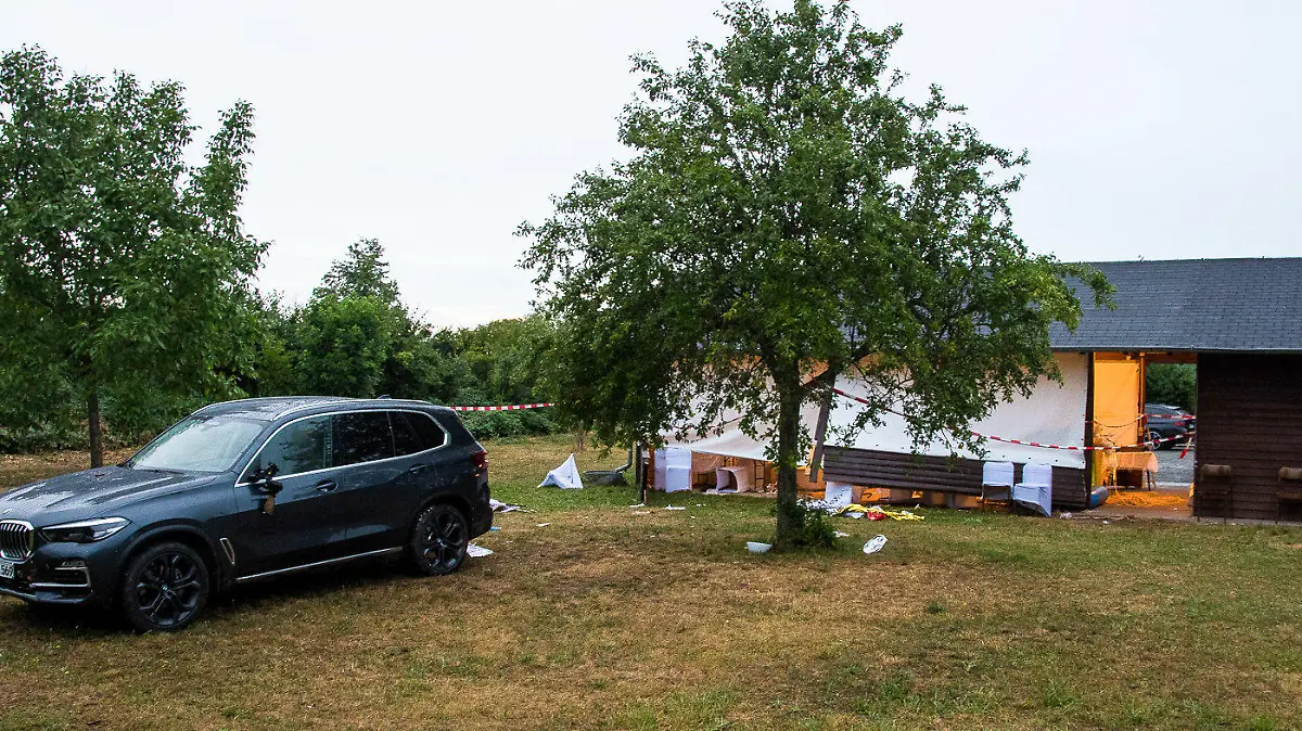 24.06.2022, Hessen, Riedstadt: Ein Auto steht hinter einer Grillhütte. Sieben Menschen bei einer Geburtstagsfeier verletzt worden, weil eine Frau mit ihrem Auto versehentlich durch einen Aufenthaltsbereich für die Gäste bei einer Grillhütte fuhr. Drei Frauen sind bei dem Unfall schwer verletzt worden, zwei davon lebensgefährlich. Foto: 5vision.Media/dpa +++ dpa-Bildfunk +++