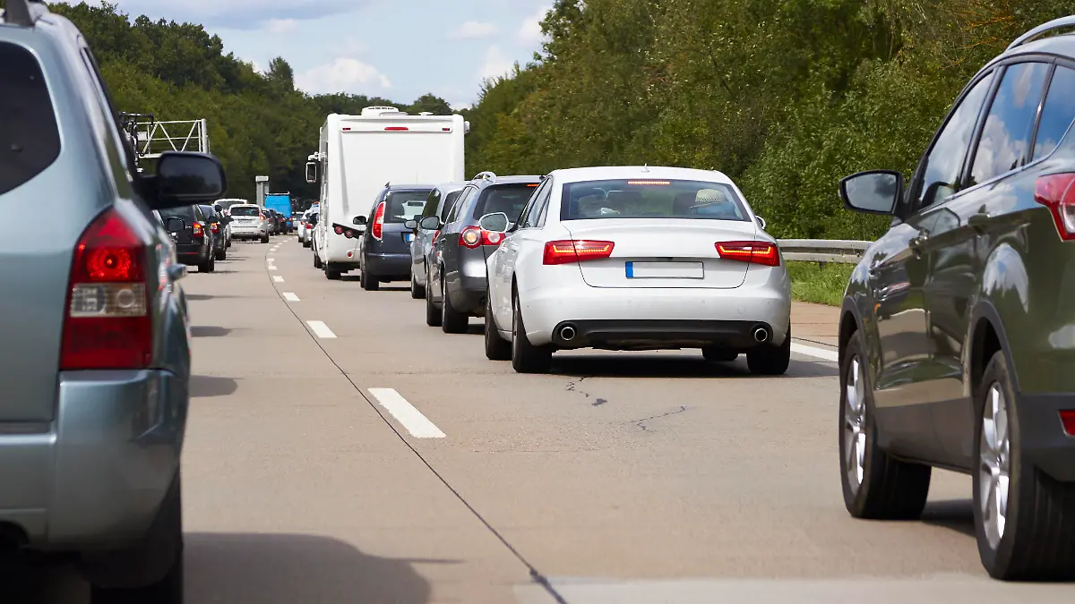 On a summer day cars jam on the highway.