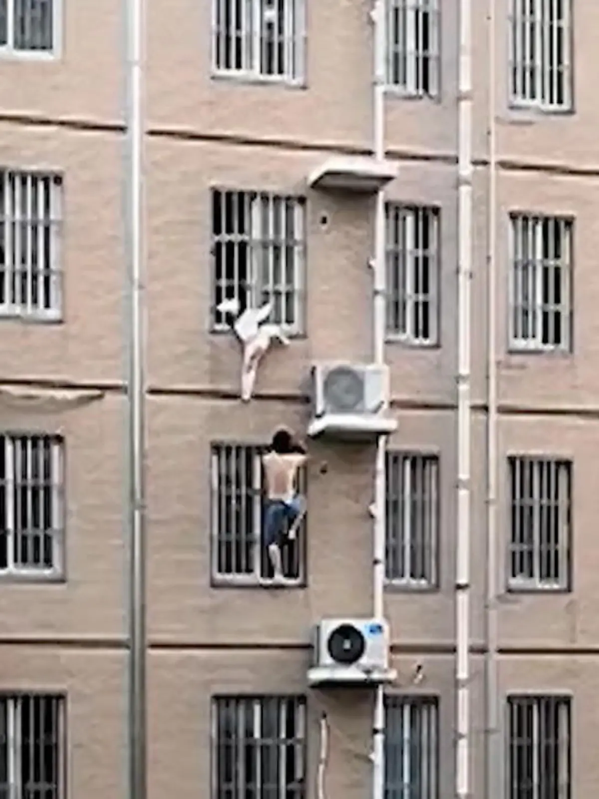 Beim gefährlichen Spielen an einem Fenster klemmt sich dieses 4-jährige Mädchen den Kopf zwischen den Sicherheitsgittern ein.
Cao Luning, der mutige Mann im Video, hat beim Abendessen Hilferufe gehört und klettert anschließend die Fassade des Hauses hoch, um das Kind zu retten.