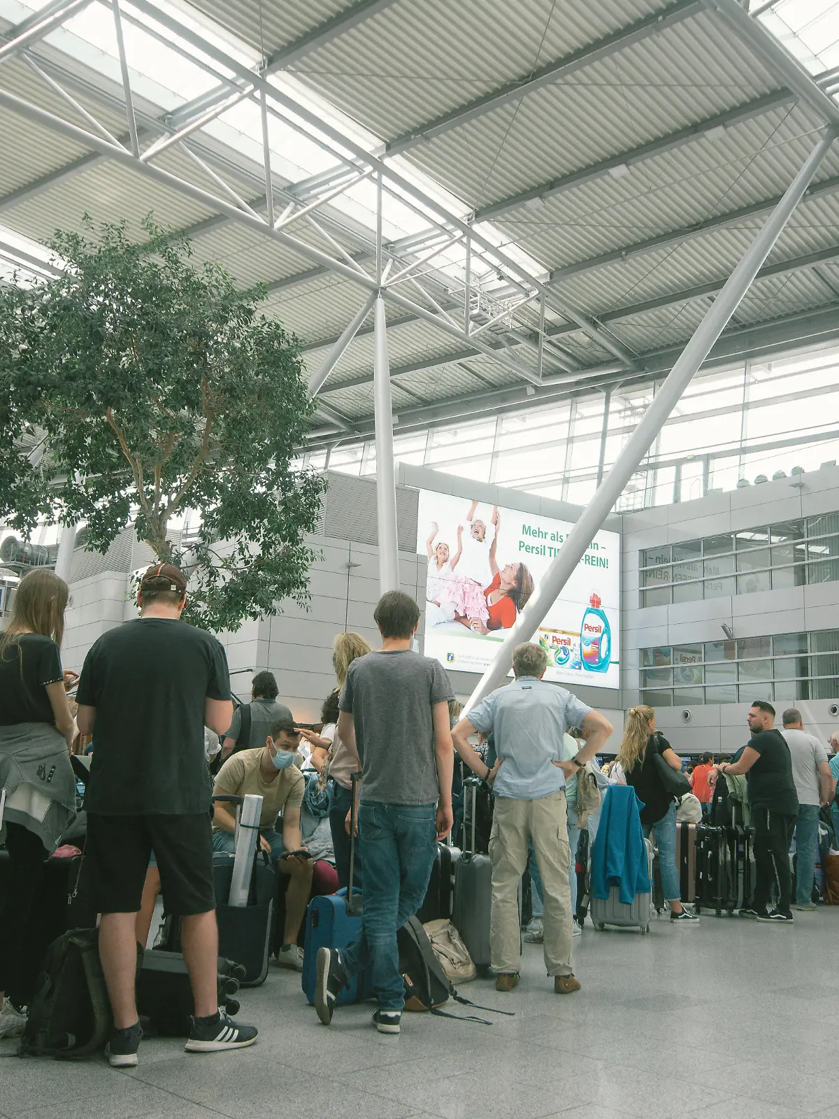 people wait in a long line in front of Tui Airways checkin counter at Duesseldorf airport on June 3, 2022 before the Pentecost holiday weekend. (Photo by Ying Tang/NurPhoto)