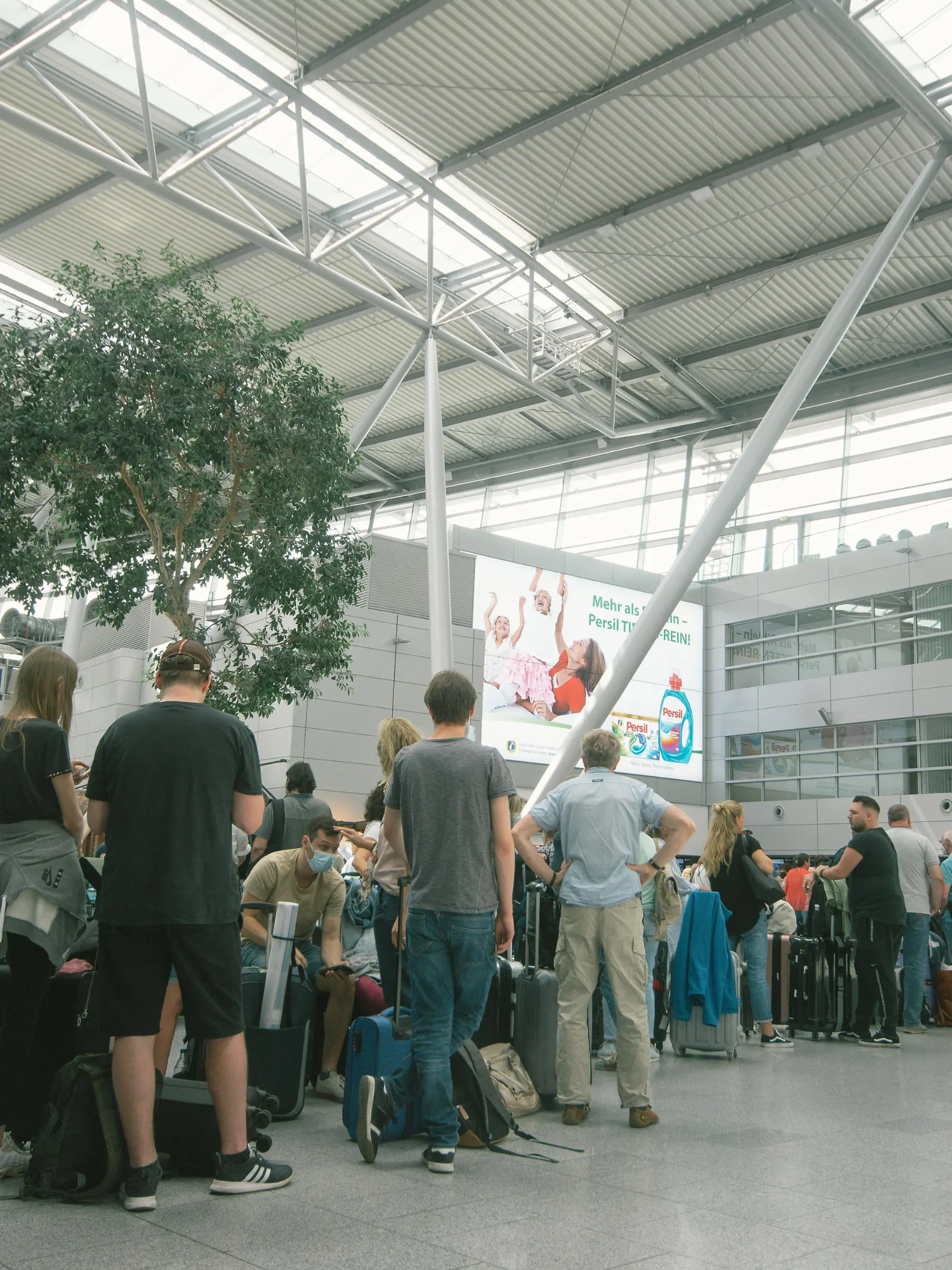 people wait in a long line in front of Tui Airways checkin counter at Duesseldorf airport on June 3, 2022 before the Pentecost holiday weekend. (Photo by Ying Tang/NurPhoto)