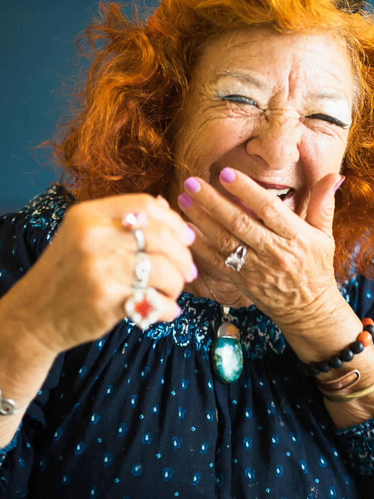 Portrait of an old lady. She laughs heartily to the viewer. She has a friendly and candid character. And a lot of fun!