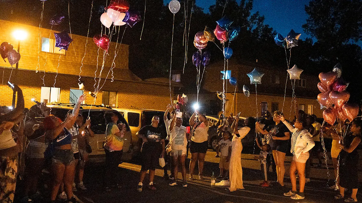 Family and friends release balloons at a private vigil Friday, Aug. 25, 2023, in Columbus, Ohio, held for 21-year-old Ta'Kiya Young, who was shot and killed a day earlier by Blendon Township police outside an Ohio supermarket. Young was pregnant and due to give birth in November, according to her family. (Courtney Hergesheimer/The Columbus Dispatch via AP)