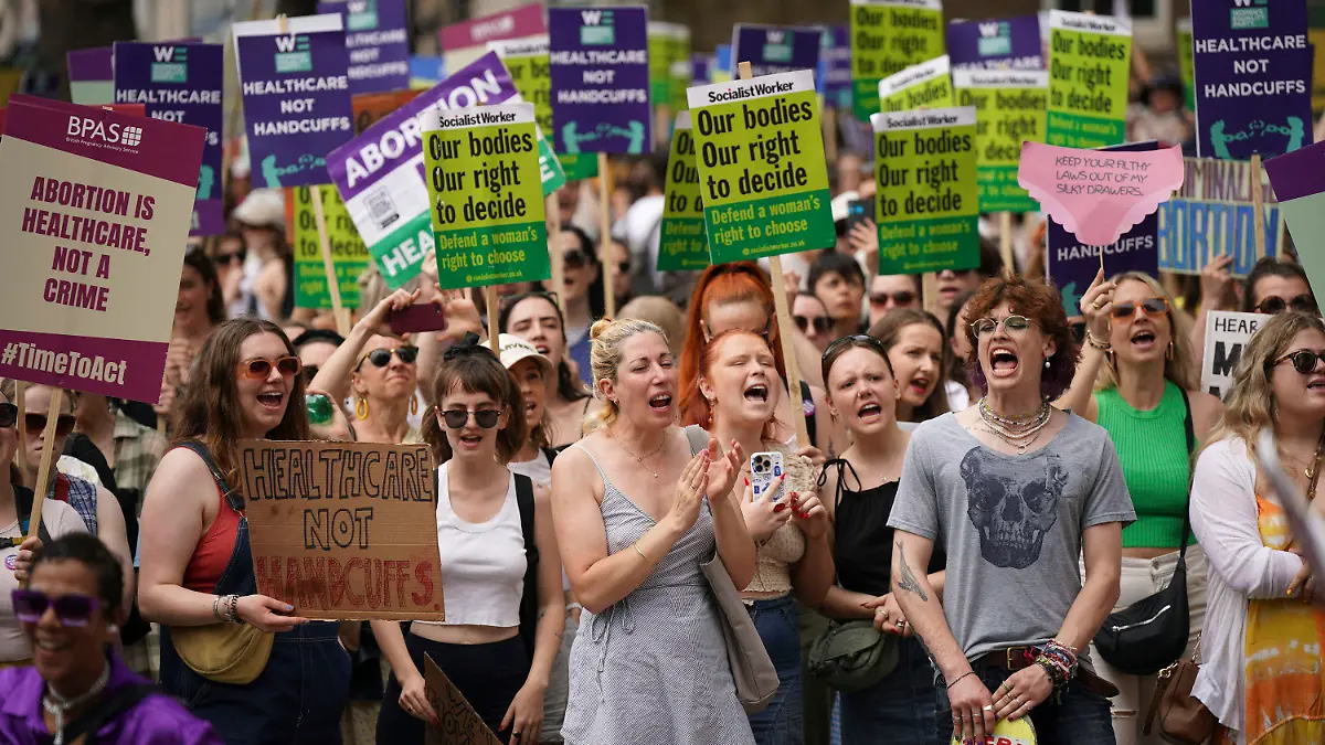 Women's rights campaigners react after taking part in a march from the Royal Courts of Justice to Westminster calling for decriminalisation of abortion, in London, Saturday June 17, 2023, following the conviction this week of Carla Foster, who illegally procured an abortion when she was at least 32 weeks pregnant. (Yui Mok/PA Wire/PA via AP)