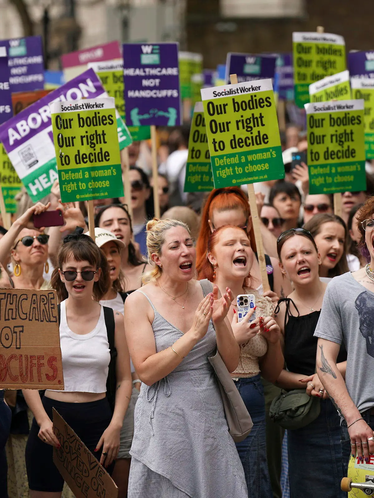 Women's rights campaigners react after taking part in a march from the Royal Courts of Justice to Westminster calling for decriminalisation of abortion, in London, Saturday June 17, 2023, following the conviction this week of Carla Foster, who illegally procured an abortion when she was at least 32 weeks pregnant. (Yui Mok/PA Wire/PA via AP)