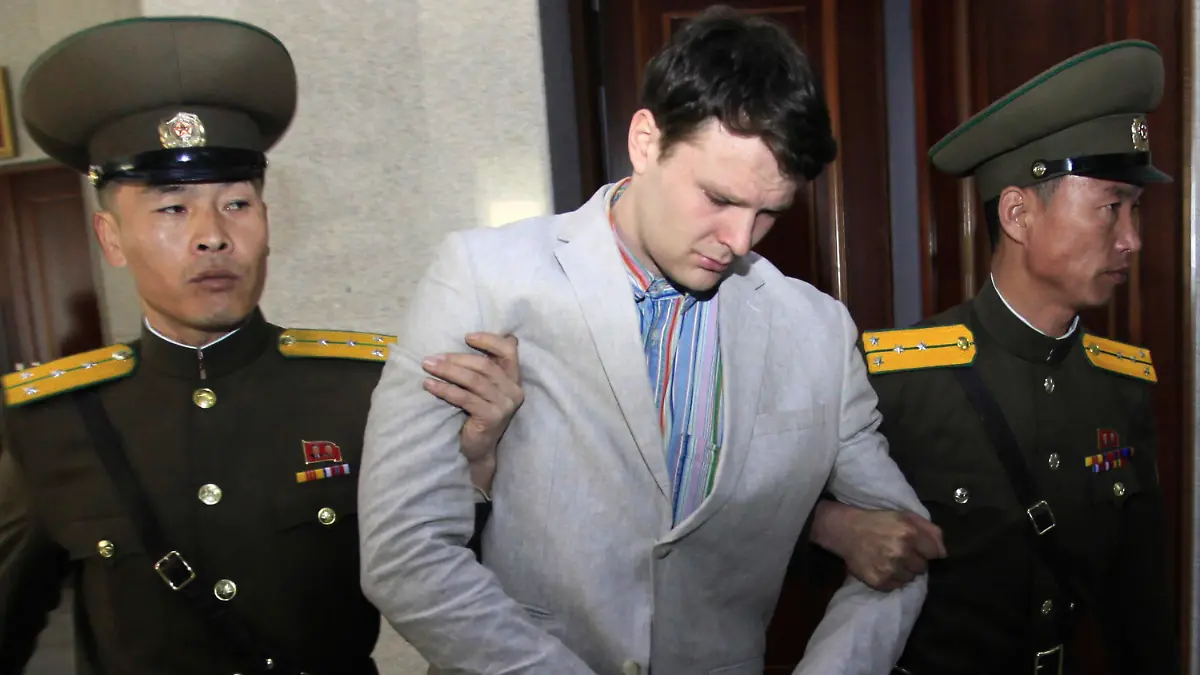 FILE - American student Otto Warmbier, center, is escorted at the Supreme Court in Pyongyang, North Korea on March 16, 2016. (AP Photo/Jon Chol Jin, File)