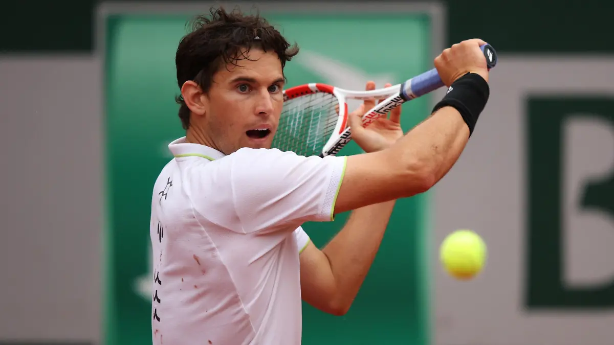 PARIS, FRANCE - MAY 22: Dominic Thiem of Austria plays a backhand during his mens singles first round against Hugo Dellien of Bolivia on day 1 of the 2022 French Open at Roland Garros on May 22, 2022 in Paris, France. (Photo by Adam Pretty/Getty Images)