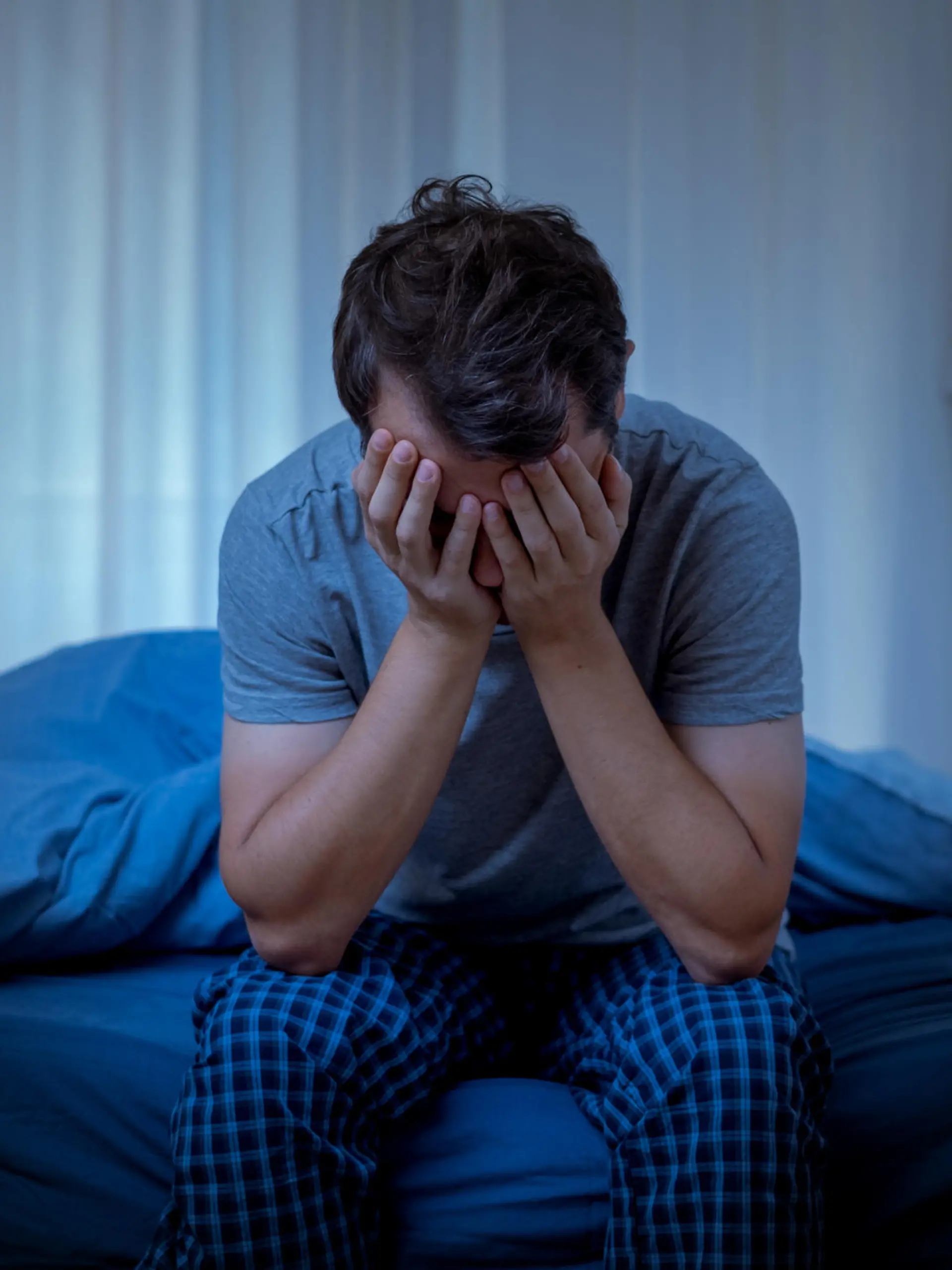 Depressed man at night feeling alone and useless