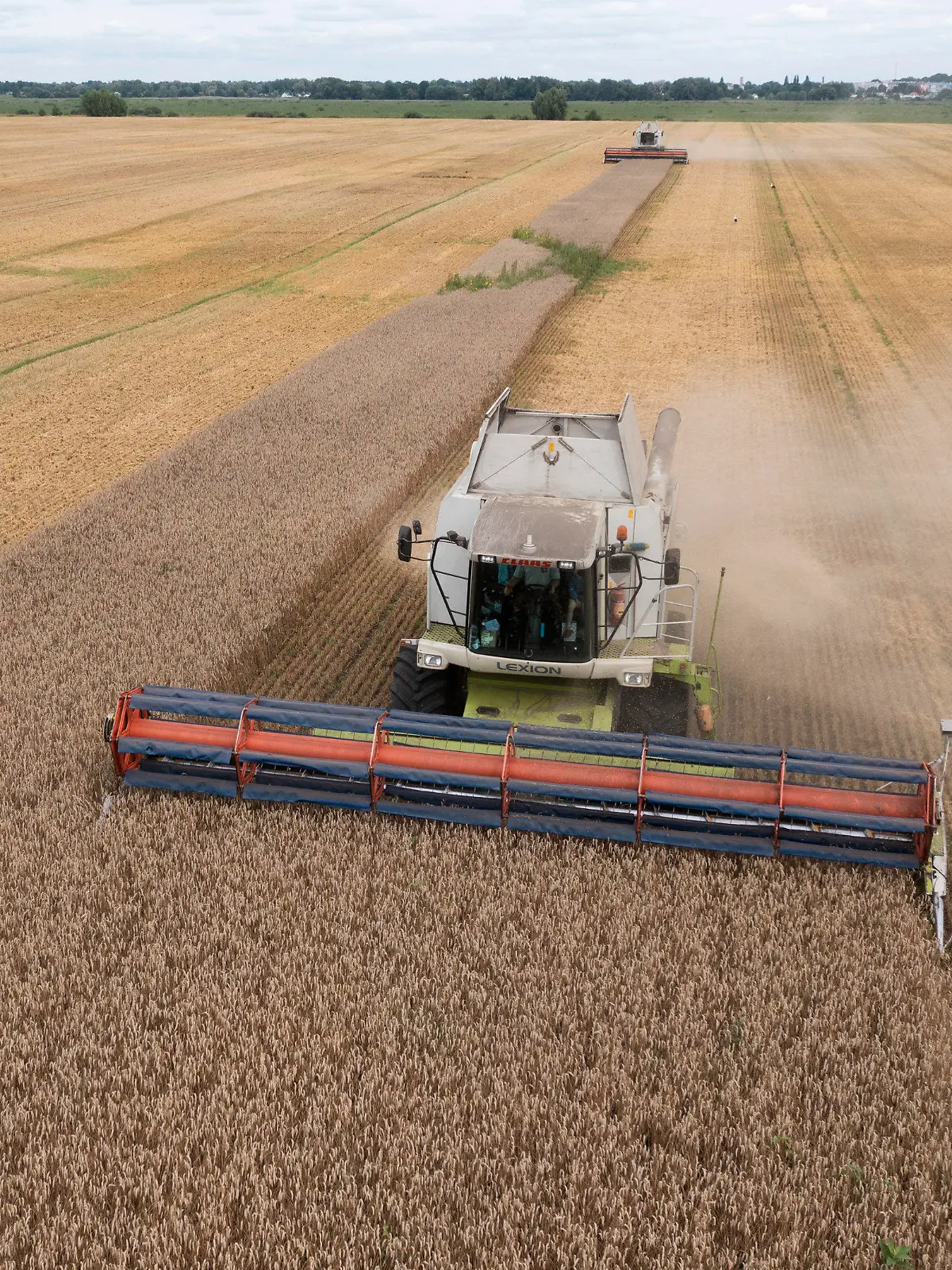 ARCHIV - 09.08.2022, Ukraine, Zghurivka: Ein Mähdrescher erntet Weizen. Russland sperrt sich gegen eine Verlängerung des Abkommens zur Ausfuhr von ukrainischem Getreide über das Schwarze Meer. Ein Auslaufen der Initiative hätte schwere Konsequenzen - für ärmere Länder und für die Welt. Das Abkommen endet am 17.07.2023 um Mitternacht Ortszeit (23.00 Uhr MESZ). Foto: Efrem Lukatsky/AP +++ dpa-Bildfunk +++