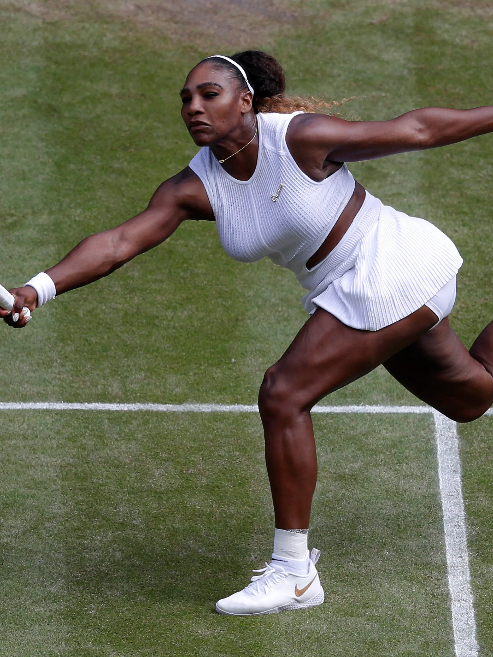 FILE - Serena Williams returns to Czech Republic's Barbora Strycova during a women's singles semifinal match on day ten of the Wimbledon Tennis Championships in London, Thursday, July 11, 2019. Serena Williams is going to play at Wimbledon this year, after all. The All England Club announced via Twitter on Tuesday, June 14, 2022, that Williams was awarded a wild-card entry for singles.(AP Photo/Alastair Grant, File)